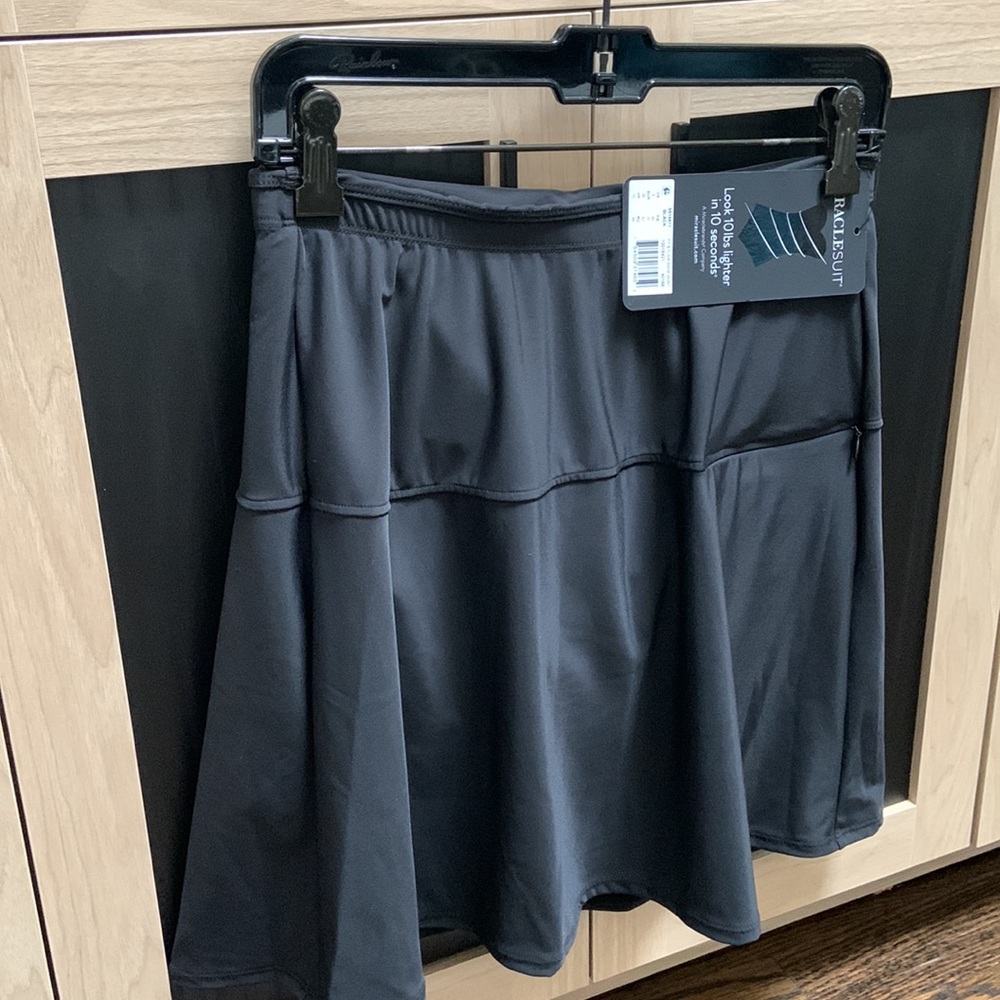 Black bathing suit skort coverup. NEVER WORN.